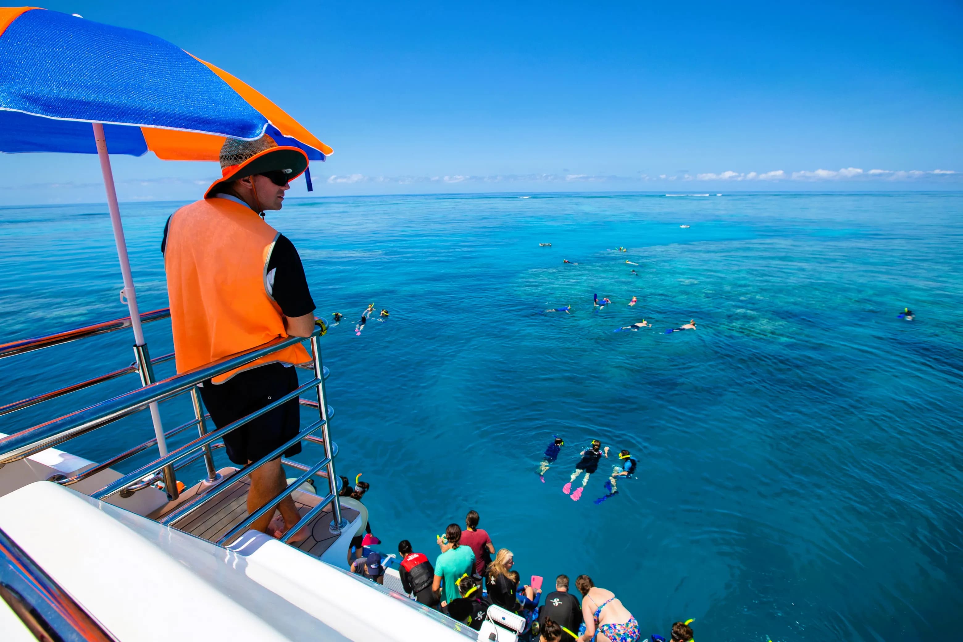 Snorkellers exploring coral gardens from Evolution